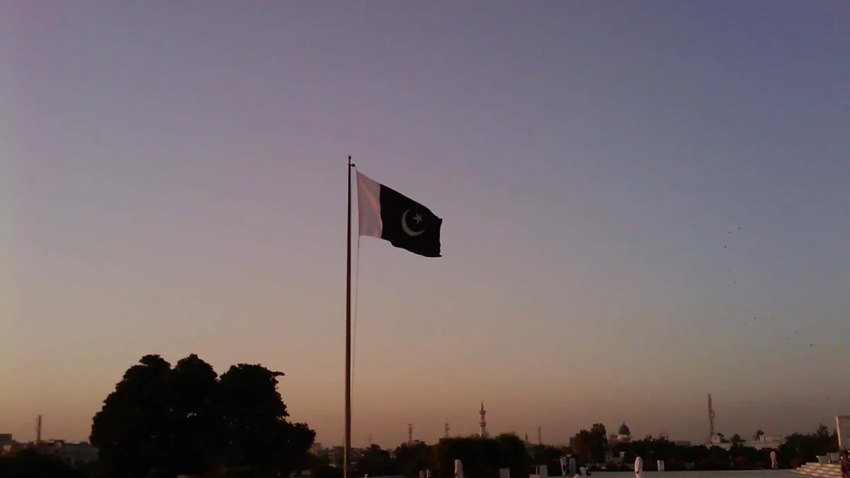 The national flag of Pakistan flying at Mazar-e-Quaid in Karachi at dusk